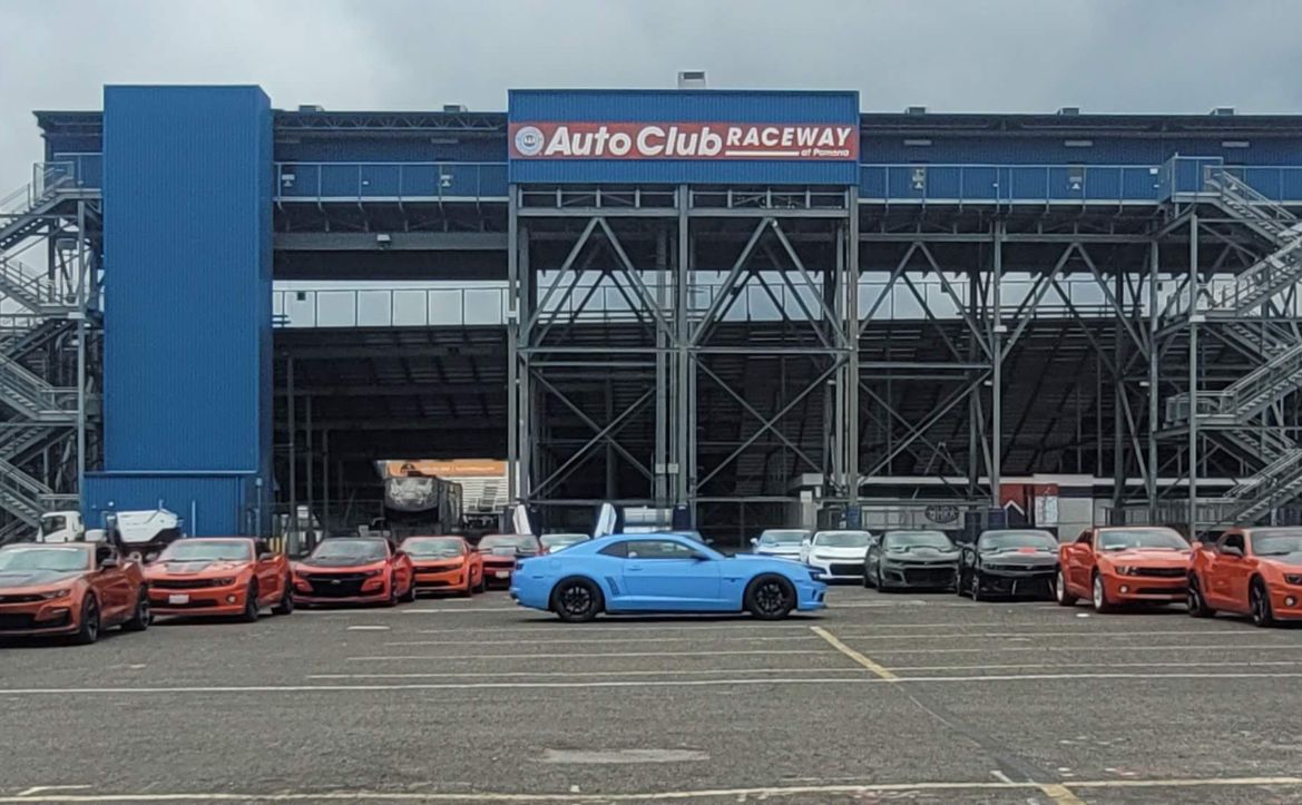 Camaro lineup parked outside Auto Club Raceway grandstands